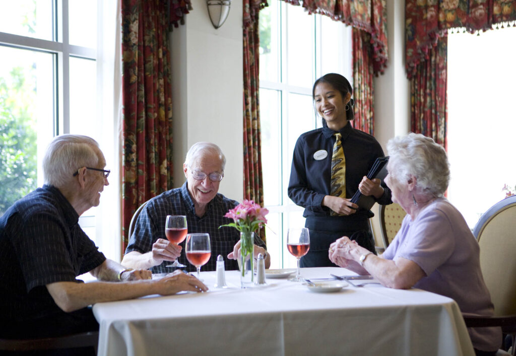 Friends gather around the table, enjoying conversation and attentive, welcoming service.