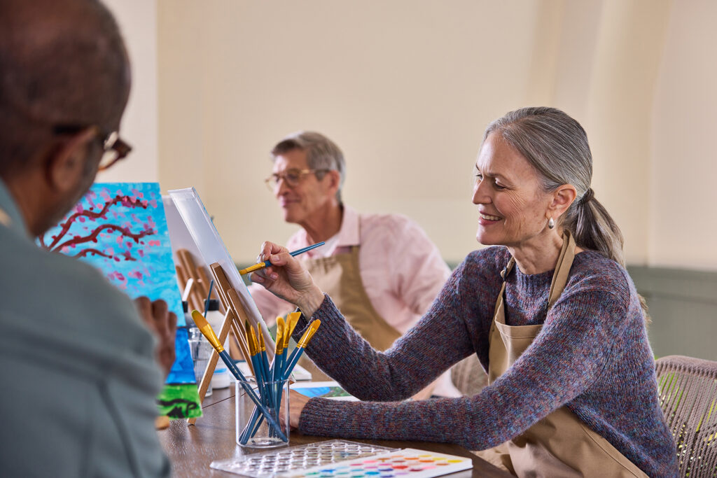 Three seniors taking an art class at The Newbury of Brookline